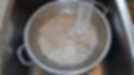 Beans being rinsed in a colander