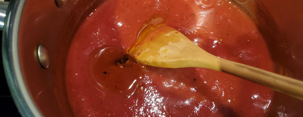 Tomato sauce, olive oil, herbs and garlic in a pot