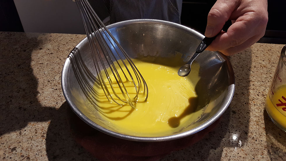 Lemon juice being added to a Béarnaise sauce in the making