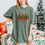 Thumbnail: MERRY comfort colors Christmas Tshirt with animal print and coquette bows