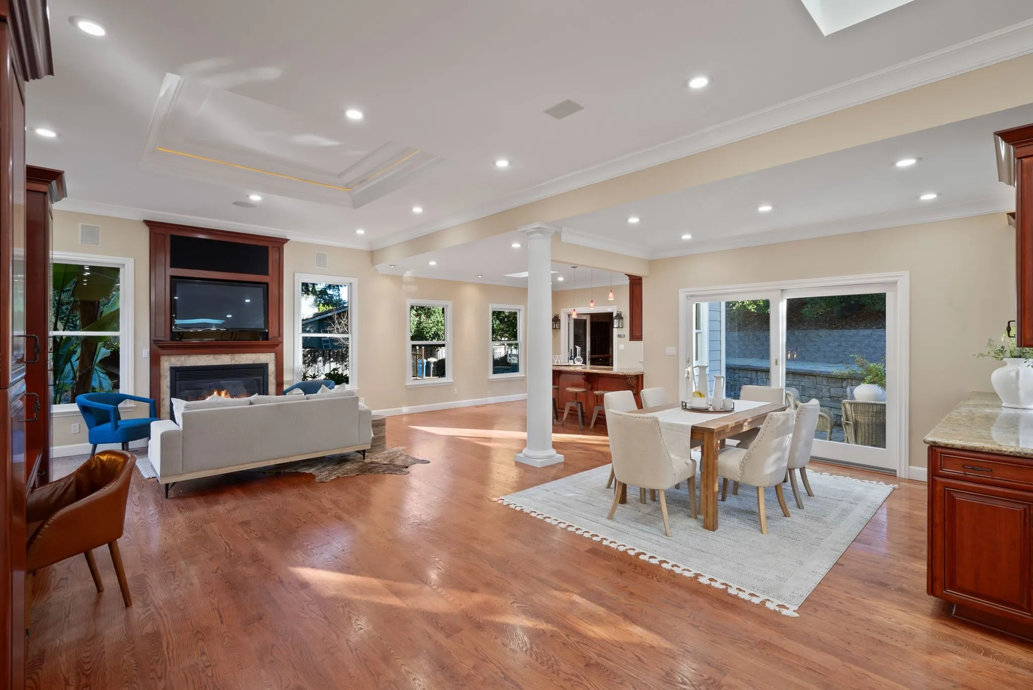 Spacious living room upgrade featuring hardwood floors, recessed lighting, and fireplace.
