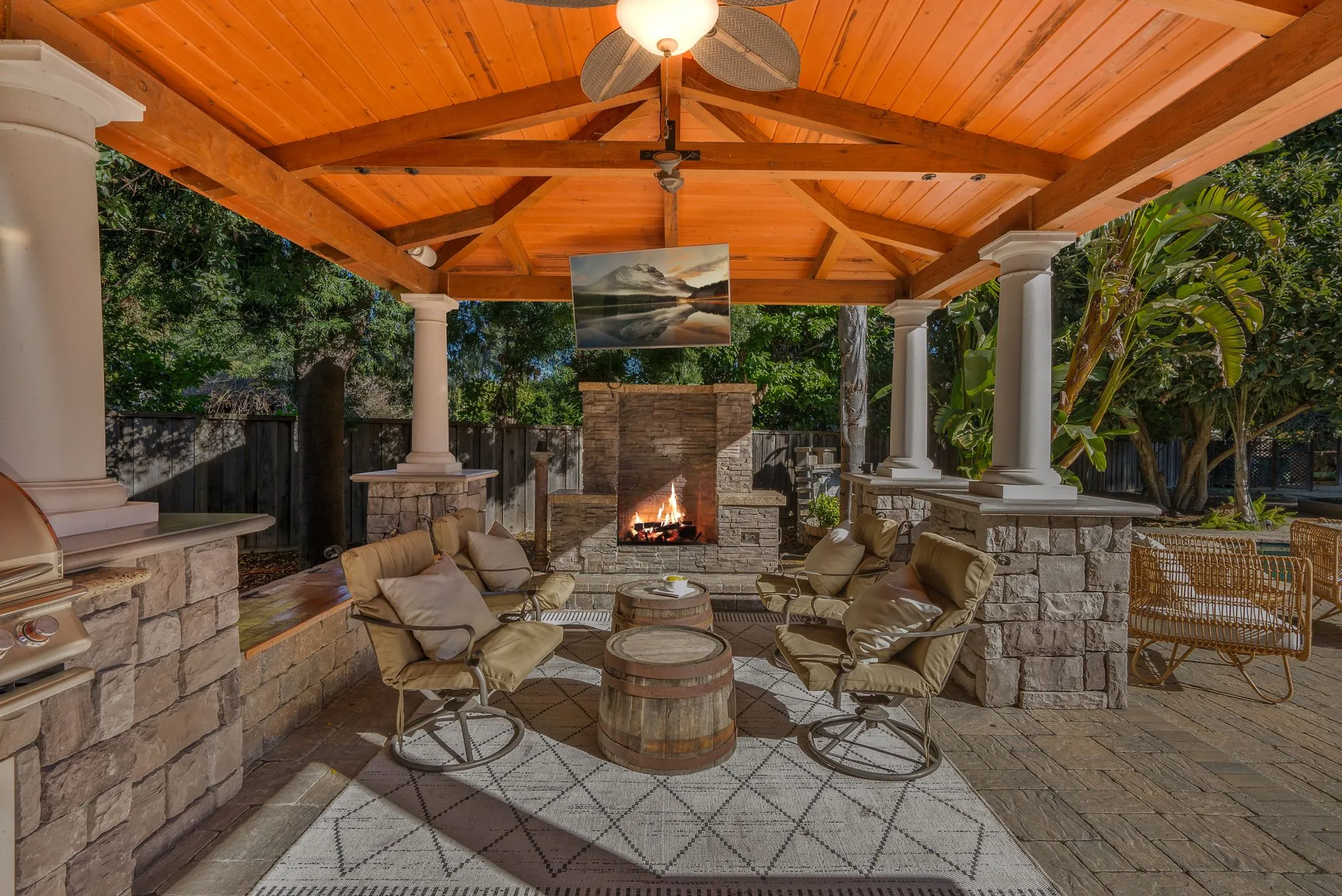 Covered outdoor space with fireplace and seating area from an ADU construction project.