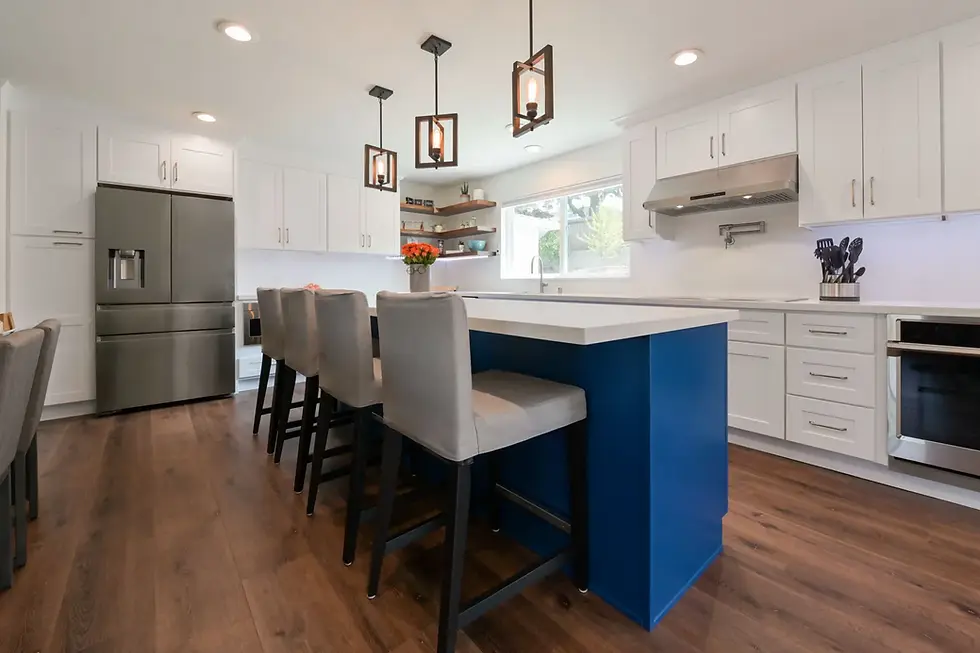 San Jose kitchen design trends 2025 featuring bold blue island, white shaker cabinets, stainless steel appliances, and wood flooring.