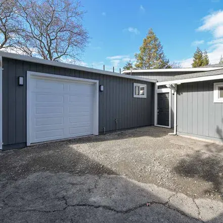 Front view of a garage, showing GBR Roofing’s roofing work on the structure.
