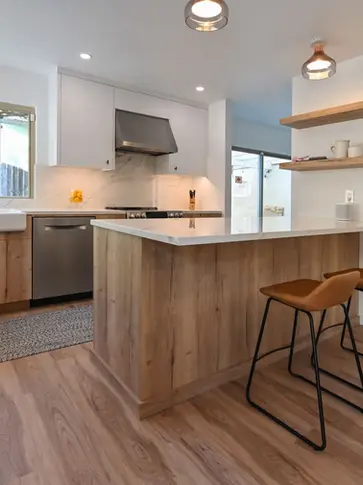 Contemporary kitchen with warm wood cabinets, quartz countertops, farmhouse sink, and open shelves – Green Bay Remodeling