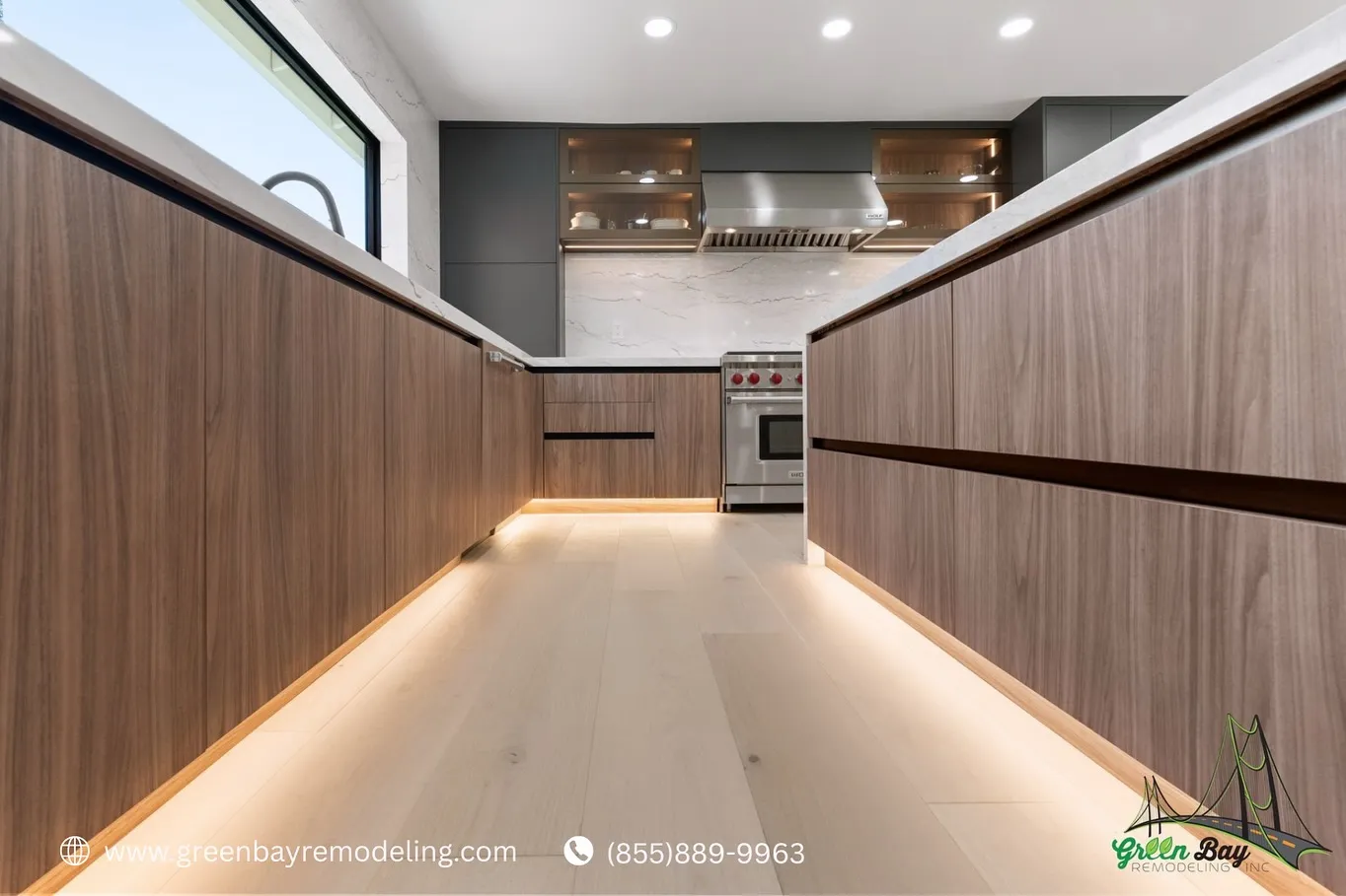 Close-up view of modern wood cabinetry with integrated under-cabinet lighting and stainless steel appliances in a contemporary kitchen remodel.