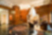 Lobby at The Royale luxury condominiums in the Upper East Side with tile floors, seating area and framed staircase.