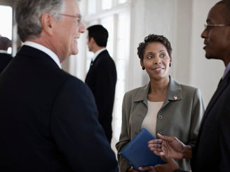 Inclusive team engaged in collaborative leadership conversation.