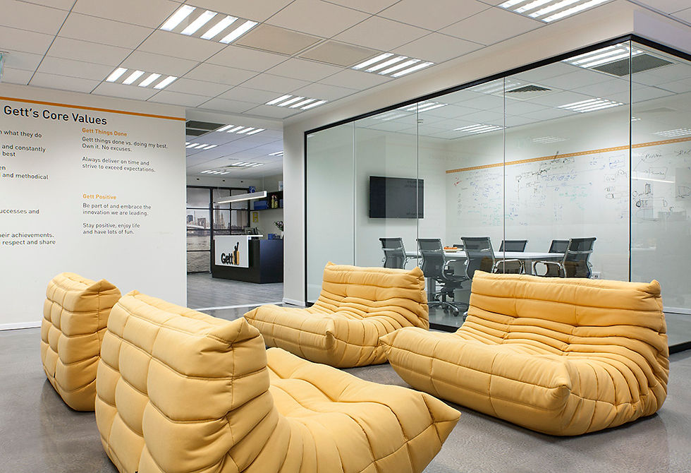 Eye-level view of a bright office corner with plants and natural light