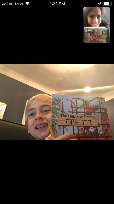 Cantor Stein giving virtual tutoring to a young boy in Old Saybrook, Connecticut