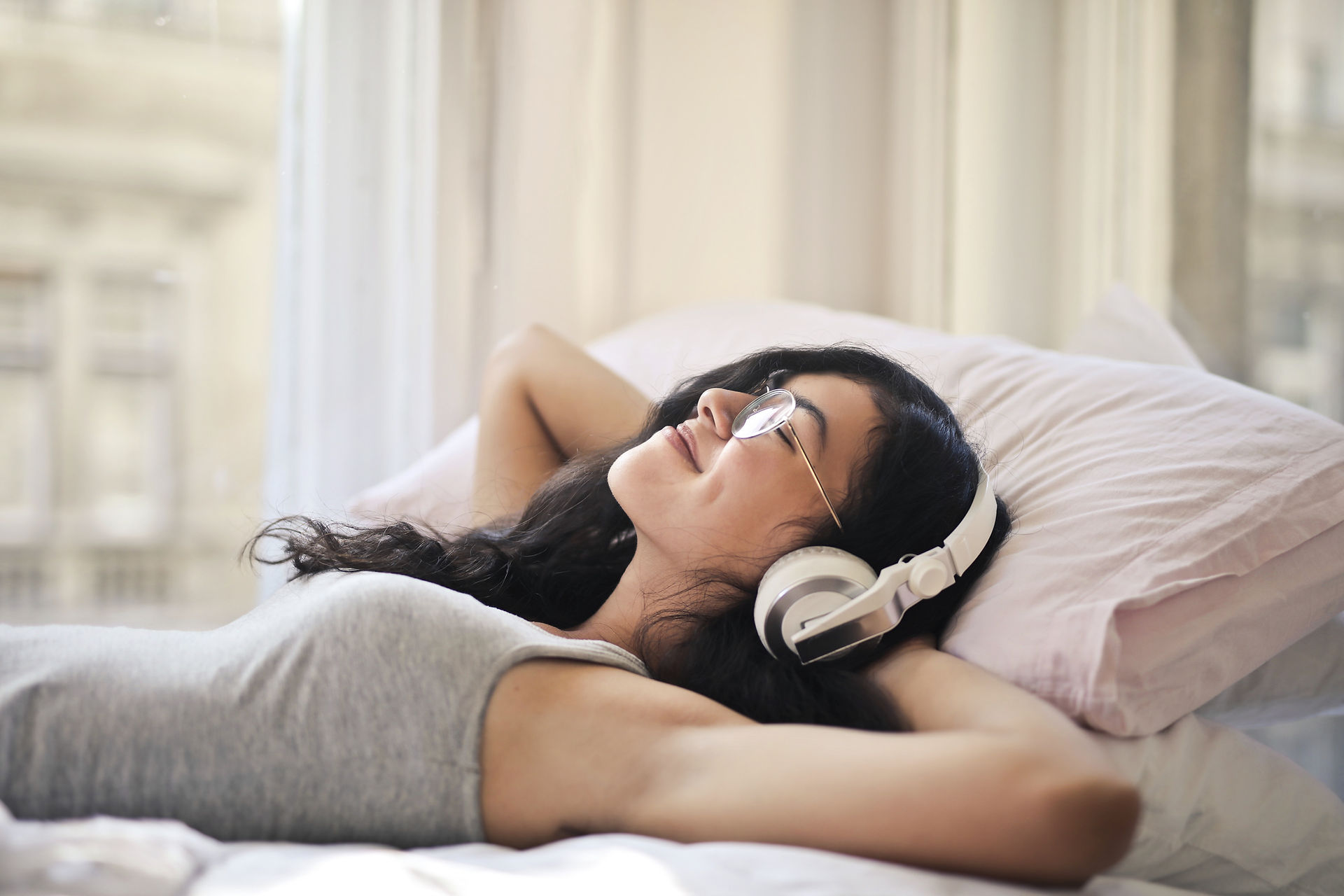 girl laying down with headphones on
