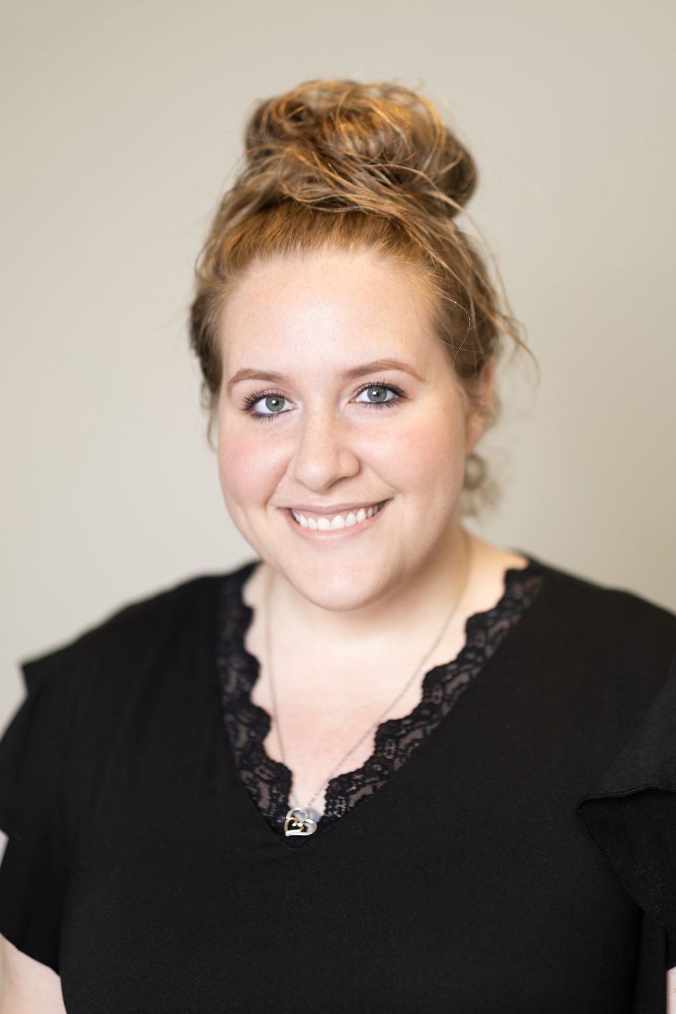 Smiling woman with topknot hairstyle