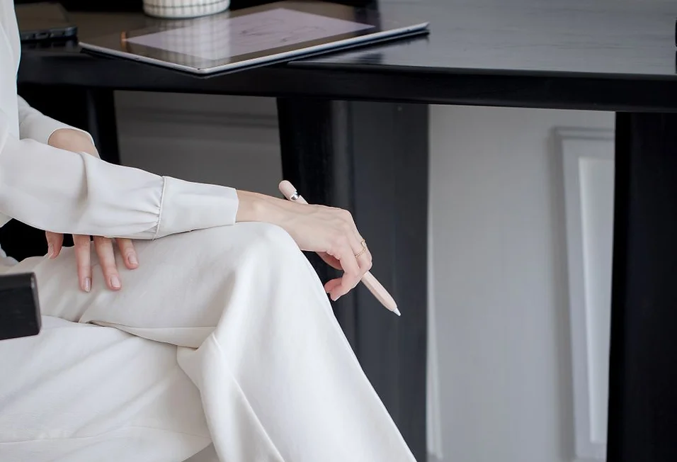 classy dressed business woman at desk
