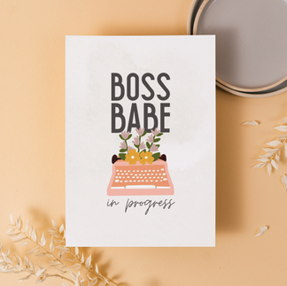 Feminine business-themed printable featuring a vintage typewriter with florals and the phrase “Boss Babe in Progress,” styled on a warm peach background.