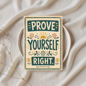 Vintage floral poster on a white plate over draped fabric, reading PROVE YOURSELF RIGHT.