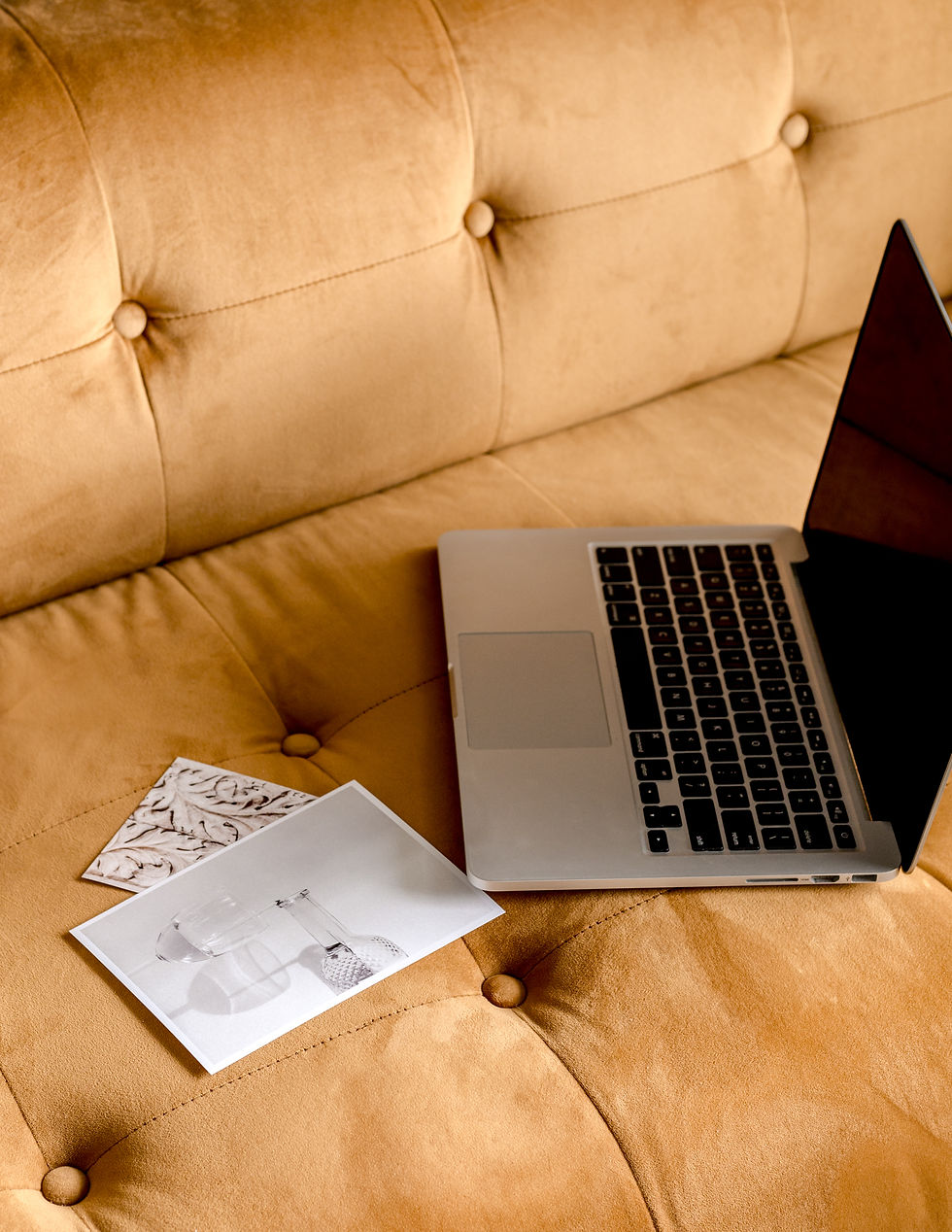 laptop on tan leather couch