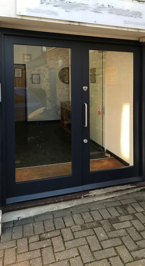 Traditional Victorian front door with a large glass panel and wooden frame.