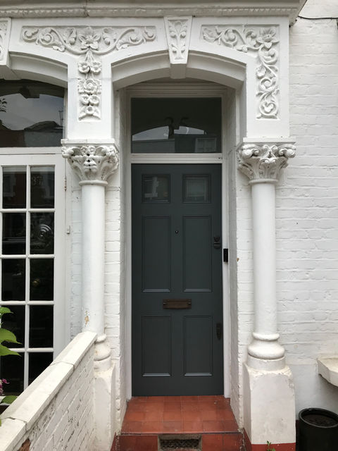 Edwardian front door with arched fanlight glass window in London period property