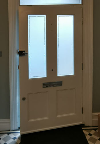 Farrow & Ball front door in soft blue with polished chrome fixtures