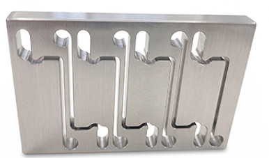 Precision Wire EDM-machined stainless steel plate with intricate slot geometry, manufactured by Atomic Machine.