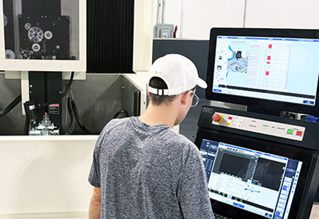 Machinist programming a Makino U6 Wire EDM machine at Atomic Machine's Naples, FL facility.