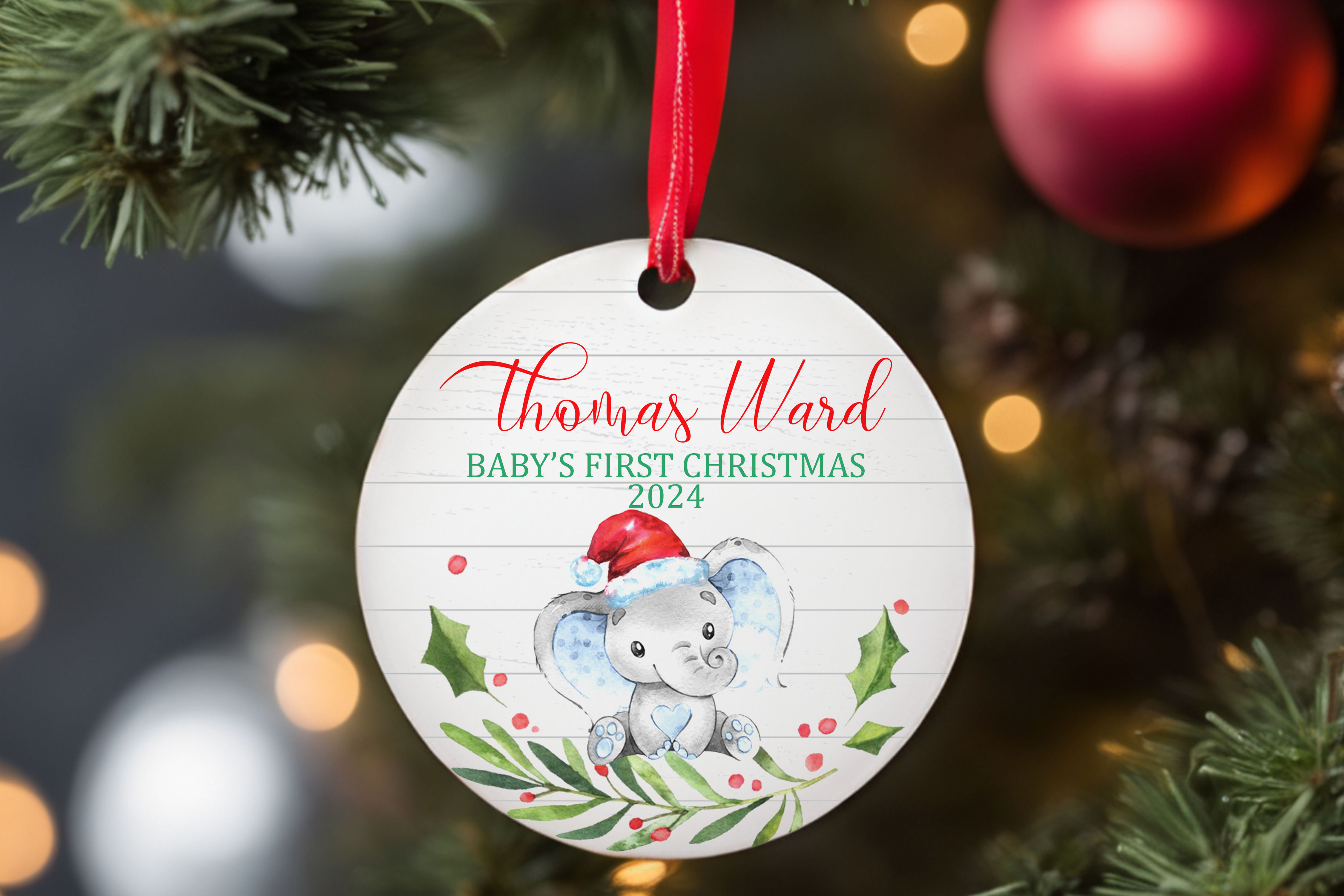 Elephant with Santa hat sitting on holly