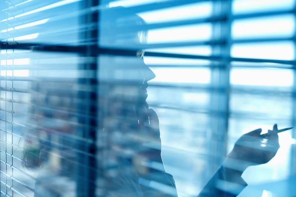 woman-in-office-talking-on-phone-near-blinds-2026-03-09-03-22-52-utc.jpg