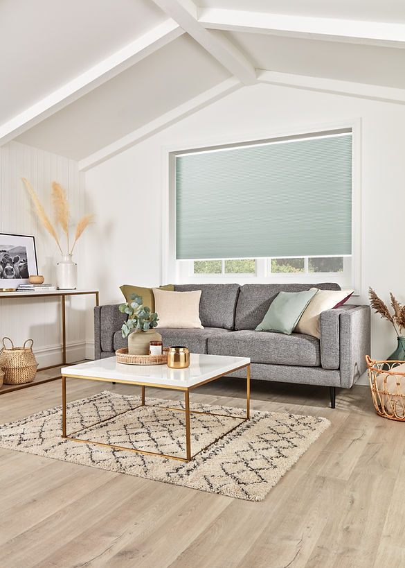 Large cellular blind, mint green fabric, grey sofa in stylish room