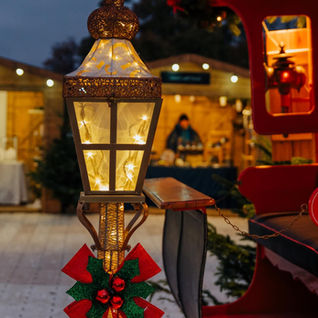A close-up on a sleigh at Chatsworth Christmas Market with a market stall/hut in the background.