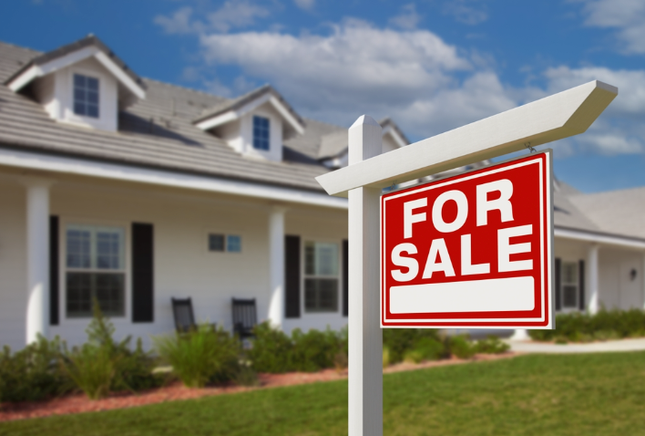 A home with a For Sale sign
