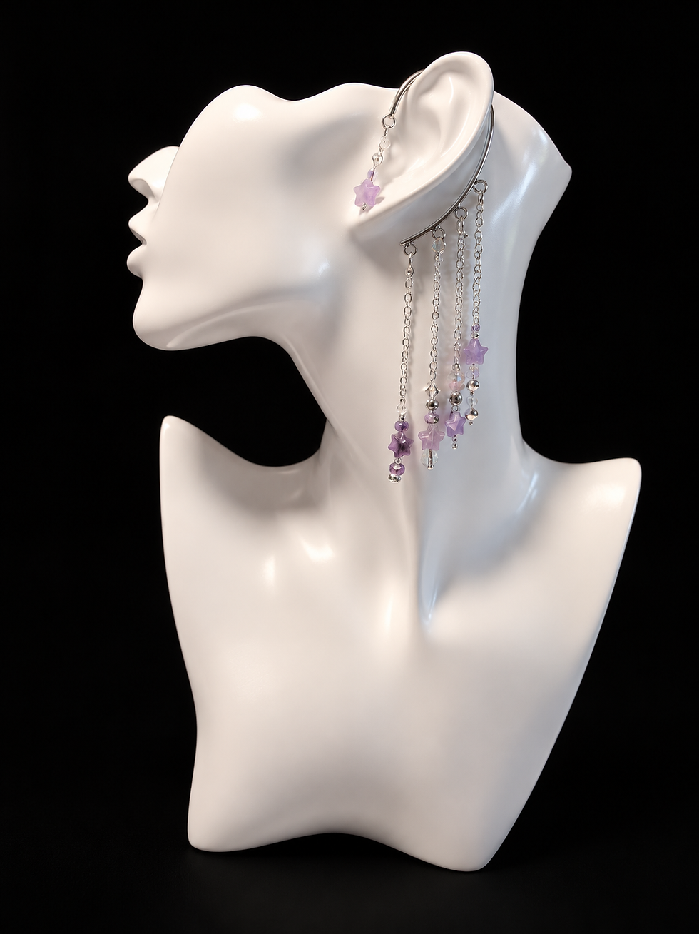 White bust with a lavender star ear cuff with four cascading silver chains.