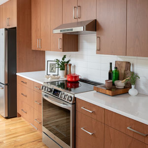 Modern kitchen with wooden cabinets and stainless steel appliances.
