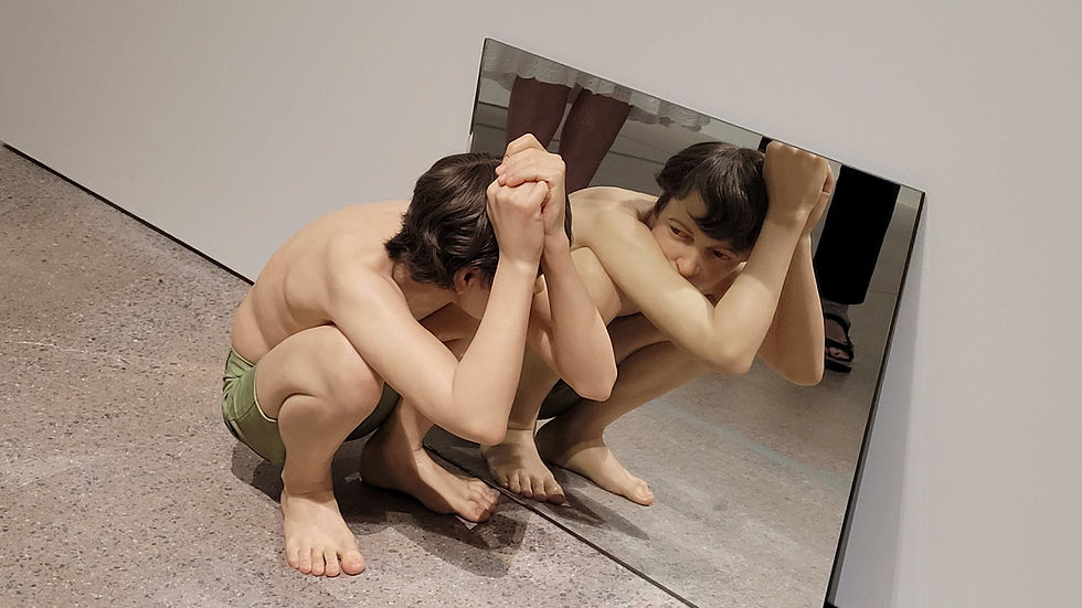 Crouching Boy in Mirror: What is he doing - is he about to flex his muscles?