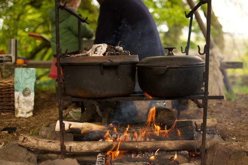 Fire cooking under canvas awning