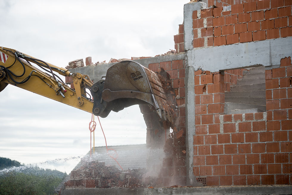 backhoe-demolishing-a-brick-house-2023-11-27-05-33-30-utc.jpg