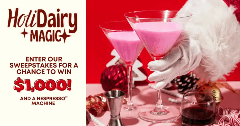 Santa's hand holding pink cocktails amid festive decorations. Left text: HoliDairy Magic, sweepstakes to win $1,000 and Nespresso.