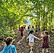 preschoolers walking & holding hands in our outdoor play area