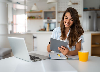 Female business person using digital tablet and laptop or remote working at home office, l