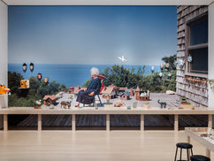 Scene with woman sitting next to seafront