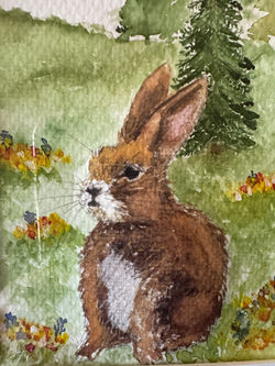 In the Peace He Provides Watercolor painting of a peaceful brown rabbit sitting in a wildflower mead