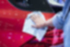 A person applying ceramic coating to a car's paint for long-lasting protection.