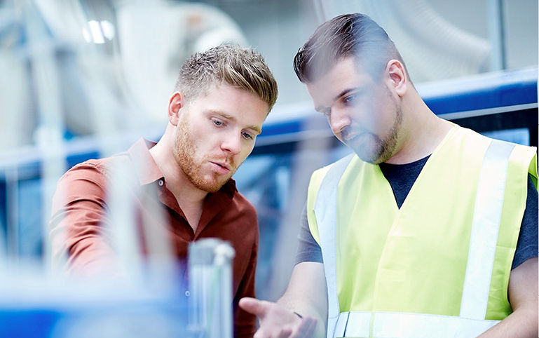 Qualified Interim managers for a Wide Range of Industries , showing two interim managers talking one wearing a yellow vest