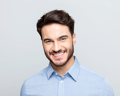 Portrait of an interim manager with a cheerful and welcoming demeanor, dressed in a light blue shirt, reflecting the approachable and professional nature required for effective management in consumer goods and retail sectors.