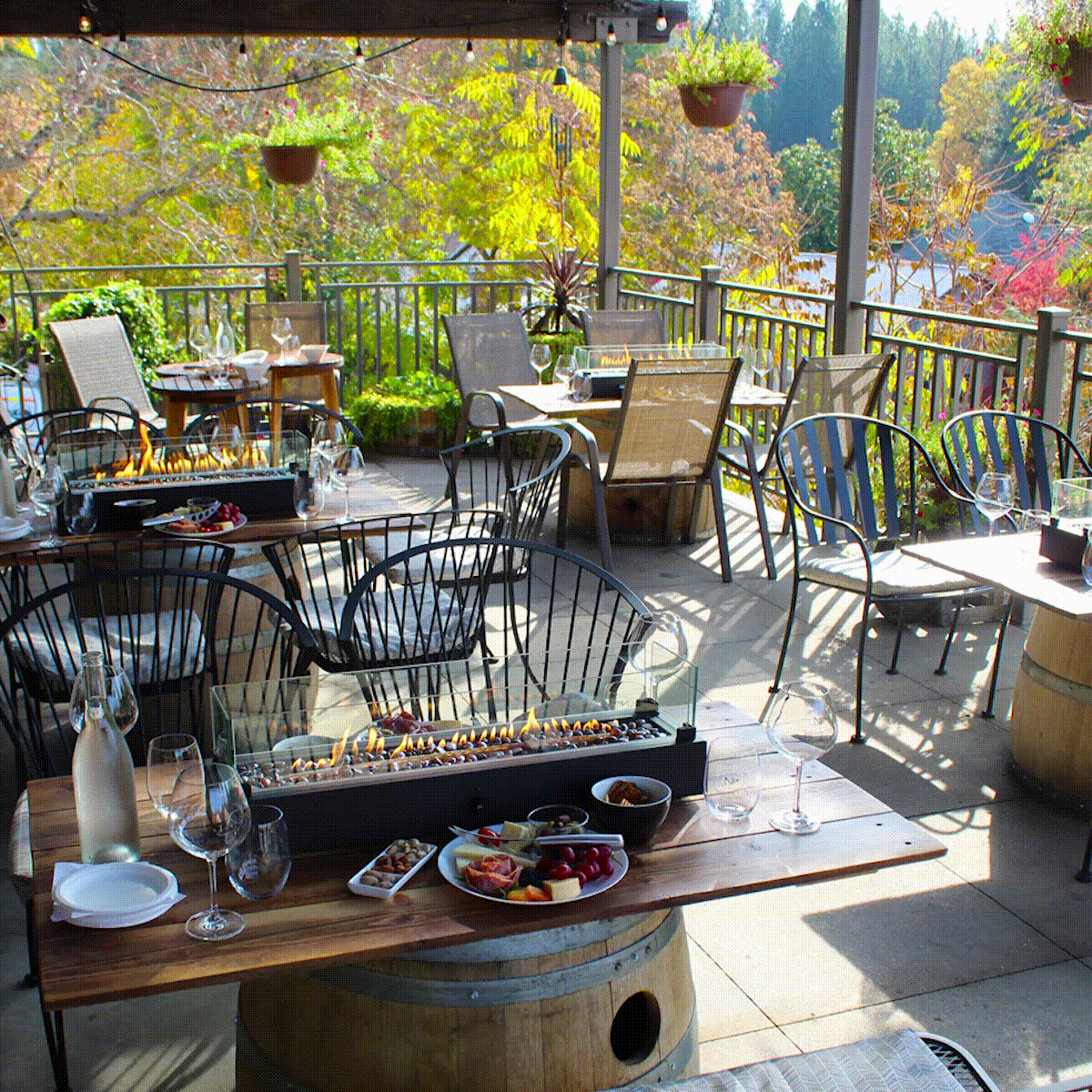 A collage of images show a covered patio with firepit tabletops, wine glasses, and charcuterie boards. Located in Nevada City, CA.