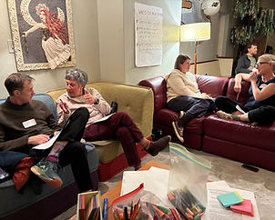People sitting on couches in pairs discuss kids & AI at a December 2025 workshop in Beacon, NY.