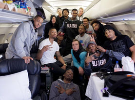 NBA players traveling together on a team plane during a road trip in the middle of the basketball season