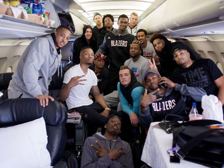 NBA players traveling together on a team plane during a road trip in the middle of the basketball season