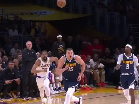 Nikola Jokić making a fast decision in transition during an NBA game between the Denver Nuggets and Los Angeles Lakers