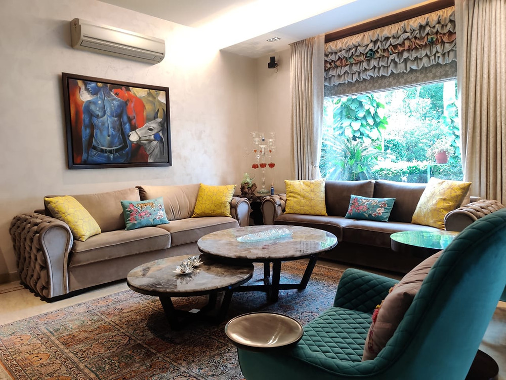 With ample natural light entering through the window & reflection of various hues, this living room acts as a catalyst for work efficiency.