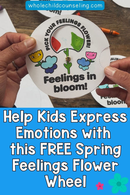 Hand holding a colorful feelings flower wheel on wood table. Text: "Feelings in bloom!" and "Help Kids Express Emotions." Background crayons.